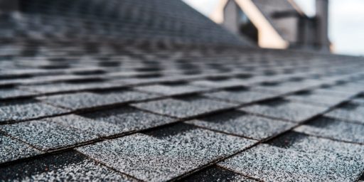 A close-up image of black asphalt shingle roofing.