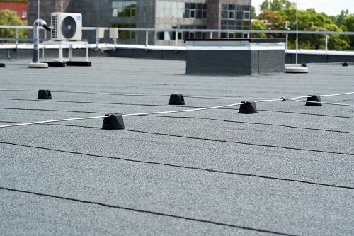 Flat roof protective covering with bitumen membrane for waterproofing.