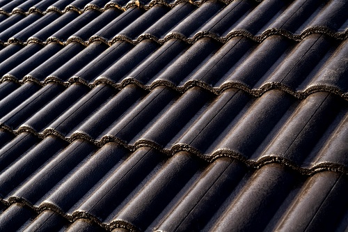 Dark brown concrete roof tiles.